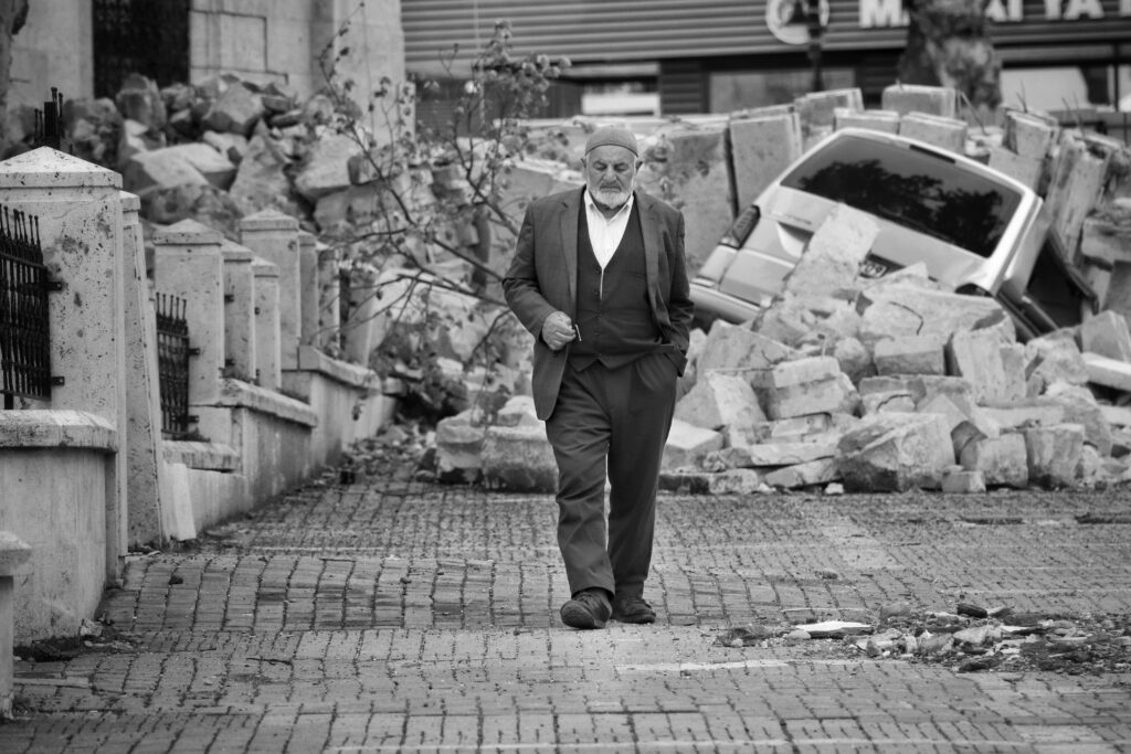 Elderly man walks past rubble after the Turkey earthquake 2025